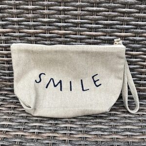 ED Smile makeup, wrislet bag